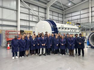 CoSEM & BCI students in front of iCOMATs large autoclave
